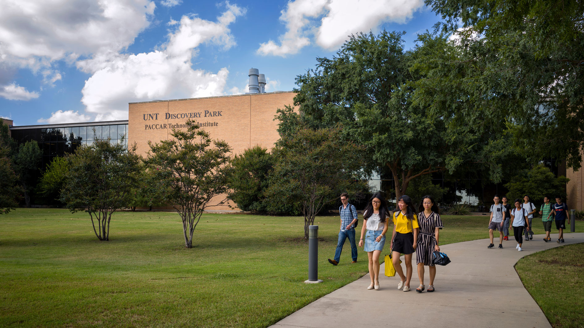 Students walking outside of building for Discovery Park.