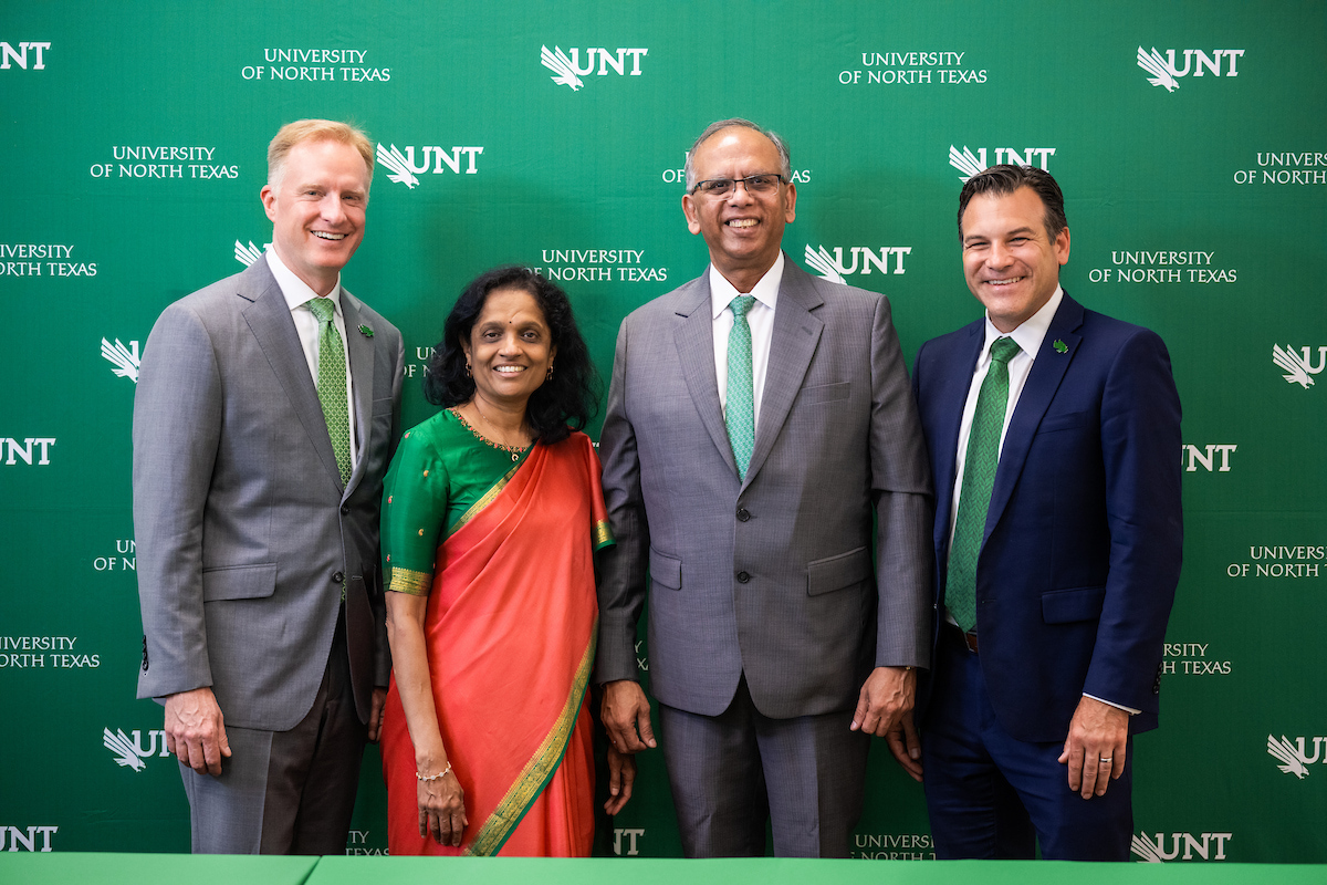 Group photo of President Keller, Anuradha and Vikas Sinha, and Brandon Buzbee